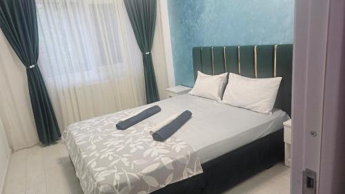 a bedroom with a bed with two pillows on it at DNY Home 2 in Giurgiu