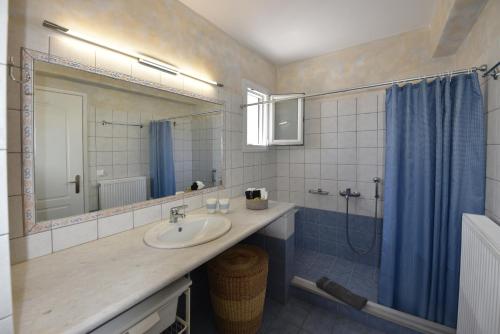 a bathroom with a sink and a shower at Anastasia Home in Triandáros