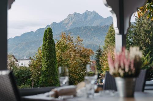 a table with a view of a mountain at Boutique Hotel Waldegg in Lucerne