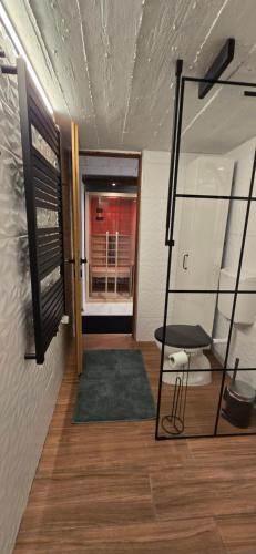 a hallway with a room with a window and a chair at Studio apartman King with private jacuzzi and sauna in Štakorovec