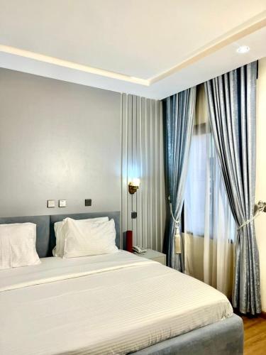 a bedroom with a large bed and a window at Valley in Kado