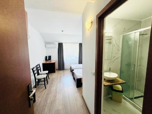 a hotel room with a bed and a bathroom at Pensiunea Delia Timișoara in Timişoara