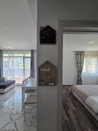a bedroom with a bed and a desk in a room at Siyana Obzor in Obzor