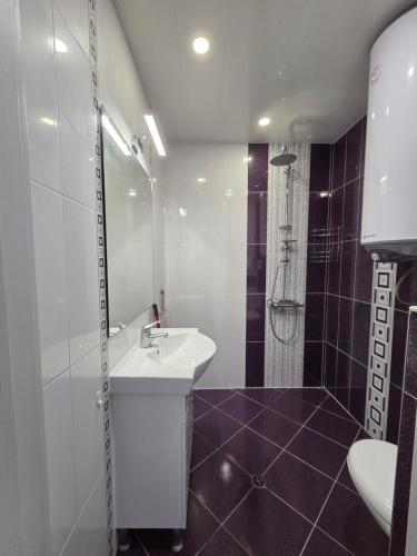 a white bathroom with a sink and a shower at Siyana Obzor in Obzor