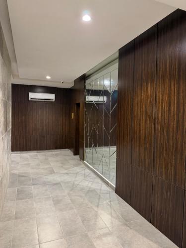 a hallway with wood paneling and a glass wall at Vinpy hotels in Uyo