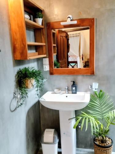 a bathroom with a sink and a mirror at Onadi House in Galle