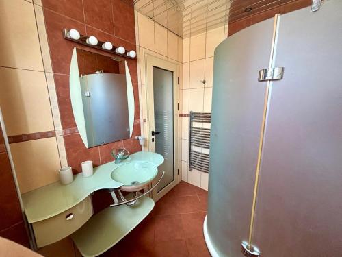 a bathroom with a sink and a shower at La Zur Guest House in Ravda