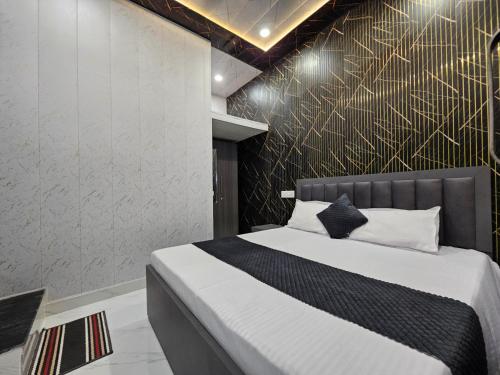 a bedroom with a bed with a gold accent wall at Royal Rani Residency in Ayodhya