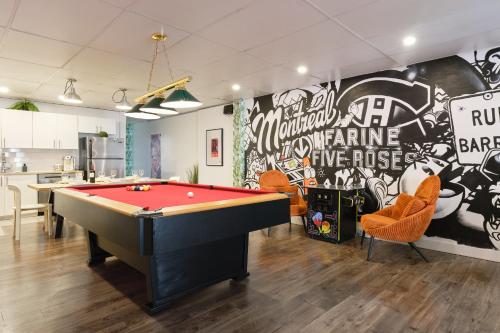a room with a pool table and a wall with graffiti at MtlVacationRentals - The Entertainer in Montreal