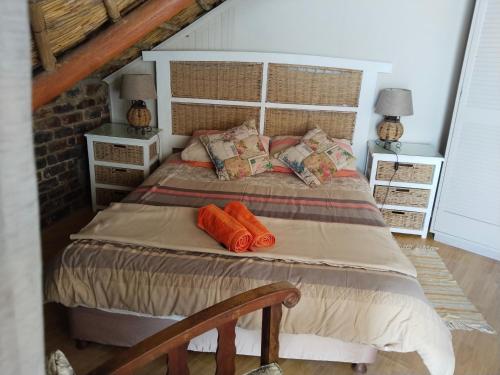 a bedroom with a large bed with orange pillows at Vinknes in Boknes