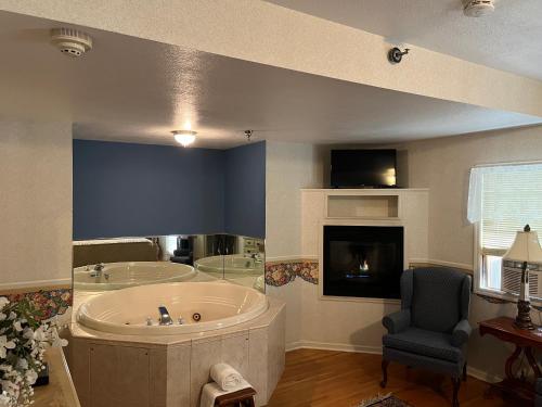 a large bathroom with a tub and a chair at Afton House Inn in Afton