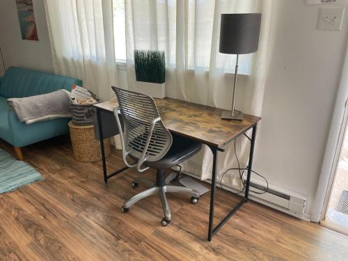a desk with a chair and a lamp in a room at Pet-Friendly Near Zion - Hot Tub Downtown Kanab in Kanab