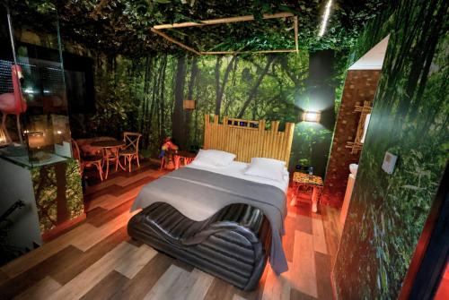 a bedroom with a bed in the middle of a forest at Motel Venus Madrid Norte in Meco