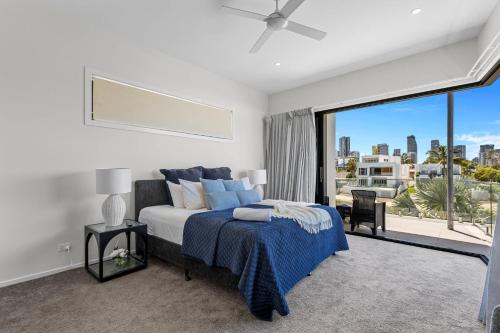 a bedroom with a bed and a large window at Wanderlust heated pool rooftop deck in Gold Coast