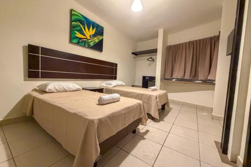 a hospital room with two beds and a window at Urbania Office Hotel in Tuxtla Gutiérrez