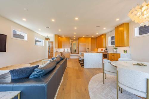 a living room with a blue couch and a kitchen at Seaview Serenity - Team Joseph Ellen in Jacksonville Beach