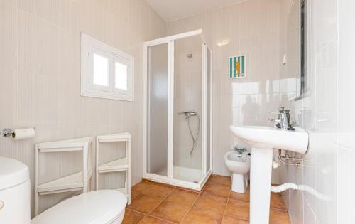 a white bathroom with a toilet and a sink at Casa Marina - Desayuno y parking incluidos in Portman