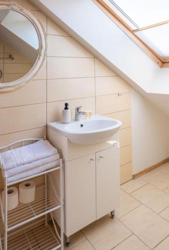 a bathroom with a sink and a mirror at Nida Inn Self Check-in in Nida