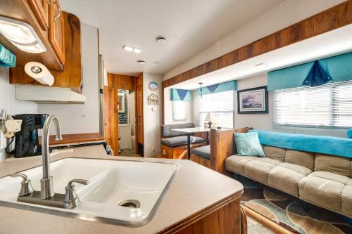 a kitchen and living room with a sink and a couch at Pool & Dock Access! Badin Lake Resort Gem in New London