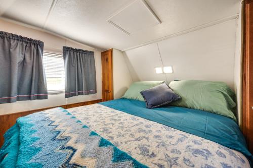 a small bedroom with a bed and a window at Pool & Dock Access! Badin Lake Resort Gem in New London