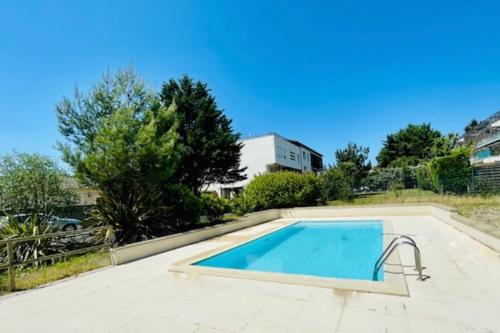 a swimming pool in the middle of a yard at Spacious cocoon with pool in La Rochelle in La Rochelle