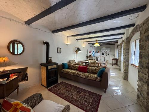 a living room with a couch and a fireplace at Casa Vigneto - Villa With Pool in Toano