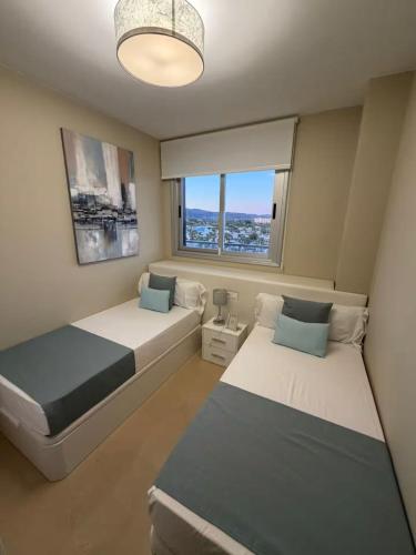 a bedroom with two beds and a window at Costa Azahar - En Primera Línea in El Borseral
