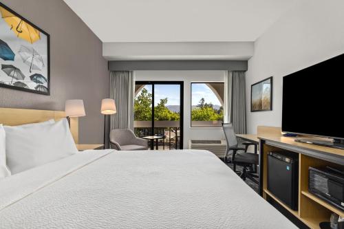 a hotel room with a bed and a flat screen tv at City Express by Marriott Mountain View - Sunnyvale in Mountain View