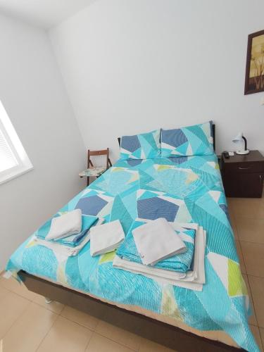 a bed with pillows on it in a room at SEA SKY View in Byala