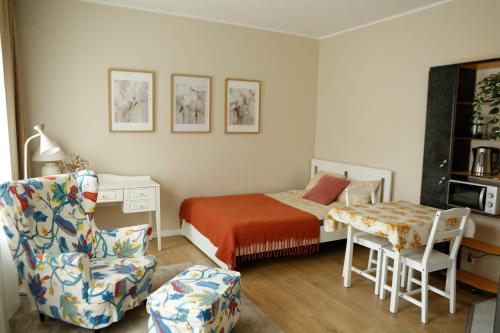 a bedroom with a bed and a chair and a desk at Center of city apartments, bus station 1min, airport 5 min in Tallinn