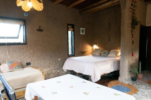 a room with two beds and two tables in it at Casa Nativa in Mendoza