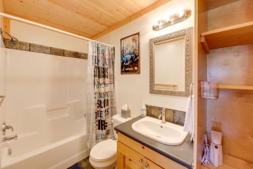 a bathroom with a sink and a tub and a toilet at Walk to Flathead Lake! Home w/ Deck & Fenced Yard! in Lakeside