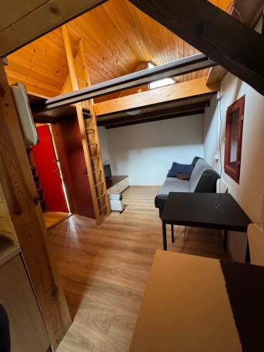 a living room with a couch and a bunk bed at Palčkov oddih in Škofja Loka