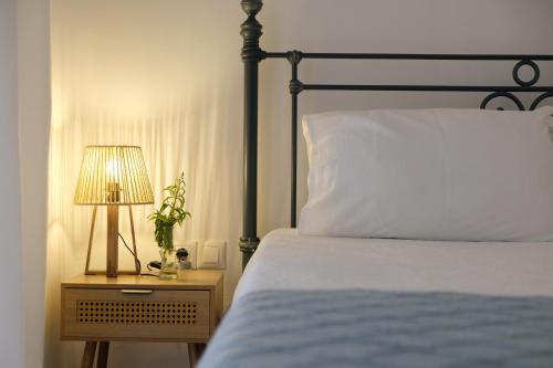 a bedroom with a bed and a lamp on a night stand at Lydía Residence - Mantoudi Evia in Mantoúdion