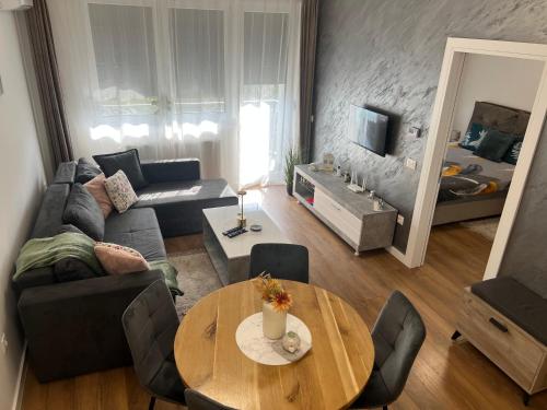 a living room with a couch and a table at Apartment VIP in Subotica