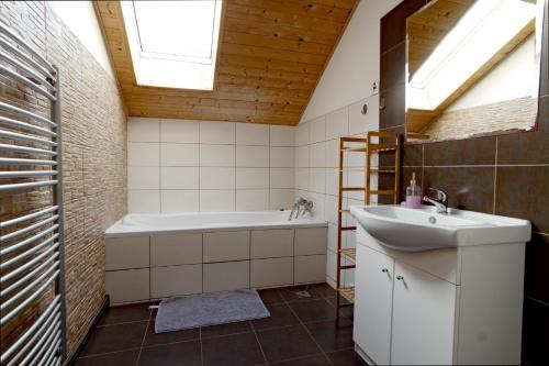 a bathroom with a bath tub and a sink at U Certa in Čerčany
