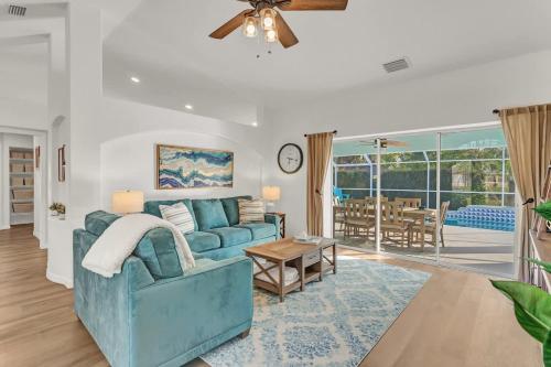 a living room with a blue couch and a table at Beach Getaway - Pool & 2 King Beds in Sebastian