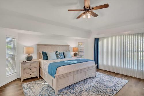 a bedroom with a bed and a ceiling fan at Beach Getaway - Pool & 2 King Beds in Sebastian