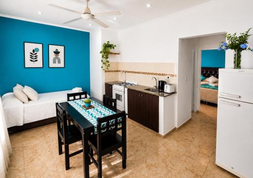 a kitchen and a living room with a table at Apartamento Lo de Ana in Termas de Río Hondo