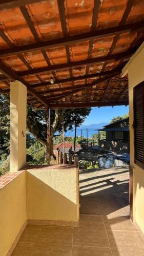 a porch of a house with a wooden roof at Casa Recanto in Angra dos Reis
