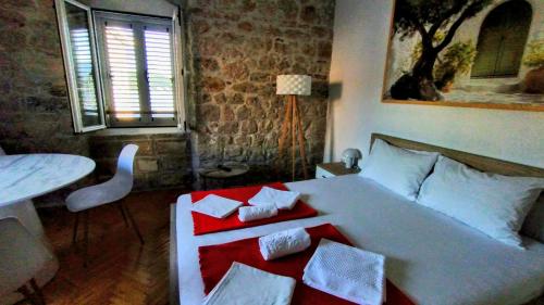 a living room with a bed and a table and a tableablish at LaRos Apt in Herceg-Novi