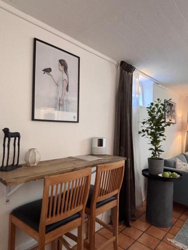 a dining room with a wooden table and chairs at Sundsvall By M - Basement Studio in Sundsvall
