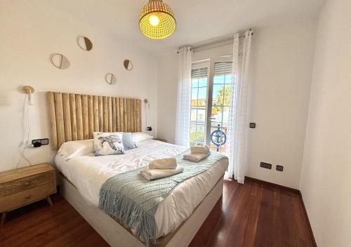 a bedroom with a large bed and a window at Xivares playa in Carrió