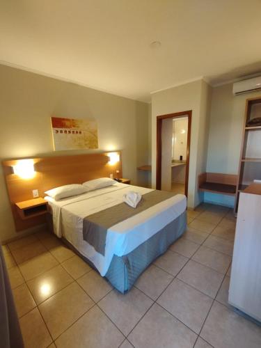 a bedroom with a large bed in a room at Savana Park Hotel in Andradina