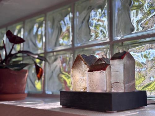 a candle holder sitting on a table with stained glass at Sundsvall By M - Basement Studio in Sundsvall