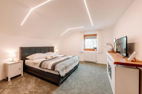 a bedroom with a bed and a television in it at Komfortable Familienwohnung in Moosham