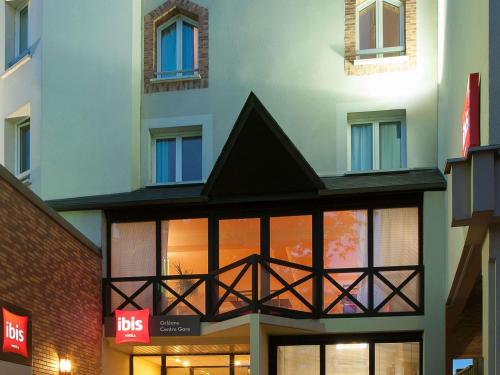 a building with a black roof and windows at ibis Orleans Centre Gare in Orléans