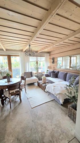 a large living room with a large bed and a table at Tatrzańska Prowansja SPA&SKI Apartamenty in Zakopane