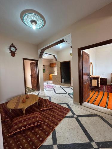 a living room with a couch and a table at Sunlight guest house in Taghazout