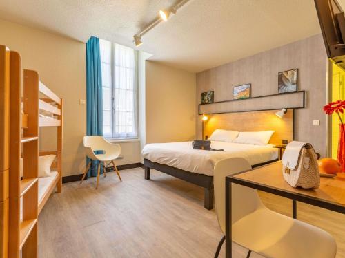 a hotel room with a bed and a desk and a bedroom at ibis Blois Centre Château in Blois